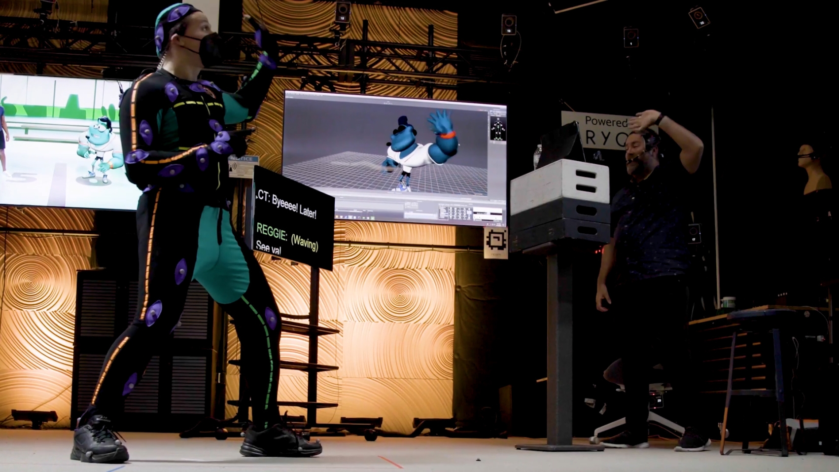 A person in a mocap suit and another person doing voice overs in real-time