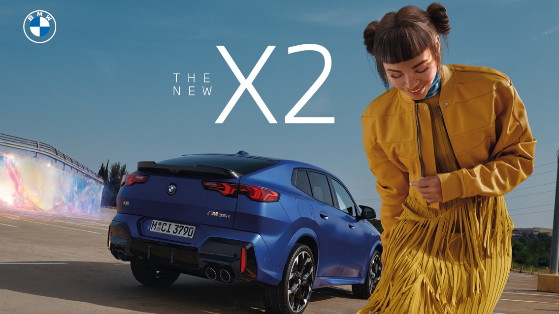 BMW The new X2 car in blue seen from the back. In front of the car you see Lil Miquela dressed in a yellow skirt and a yellow jacket.