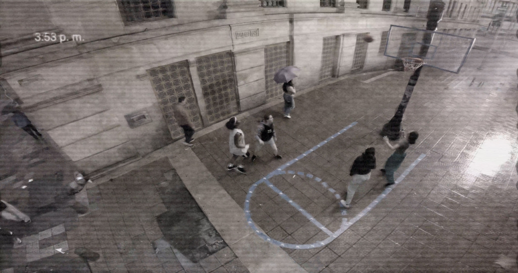 A camera view of a sports court with people playing