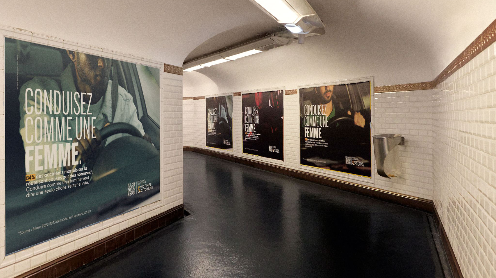 The image depicts an underground passage lined with posters promoting safe driving, using the slogan "CONDUISEZ COMME UNE FEMME," while statistics indicate that 84% of road fatalities involve men.