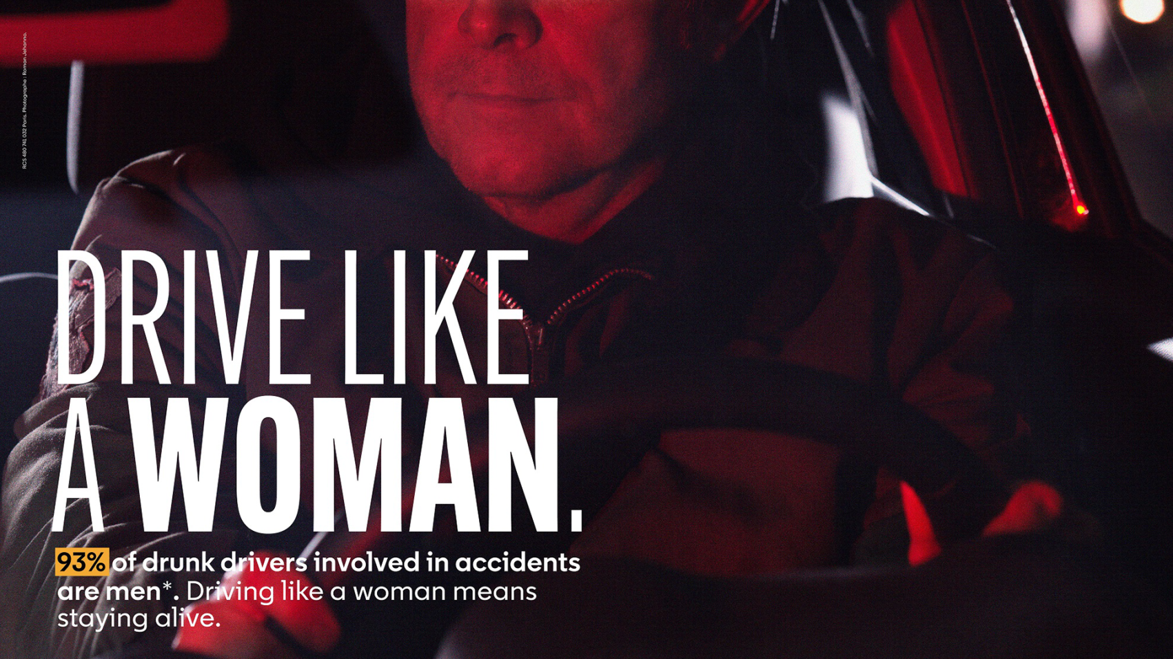 The image depicts a man driving at night with a serious expression, accompanied by text stating "DRIVE LIKE A WOMAN" and highlighting that "93% of drunk drivers involved in accidents are men," promoting safer driving practices.