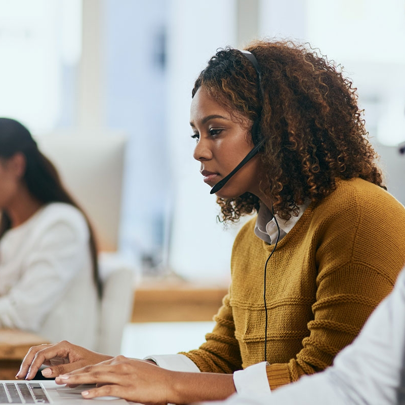 Woman working at desk wearing a headset