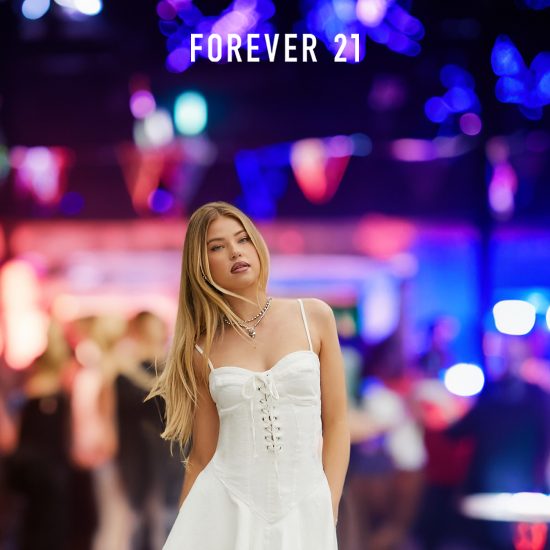 Woman wearing Forever 21 clothing on a busy street at night