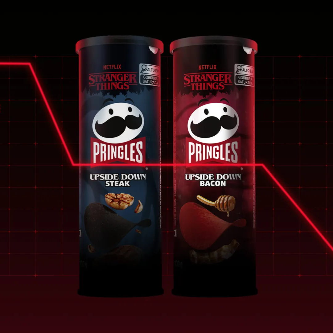 Two Stranger Things edition Pringles cans, Upside Down Steak and Upside Down Bacon, on a black grid with a red price line dropping and the text "The scarier the episode, the cheaper Upside Down Pringles