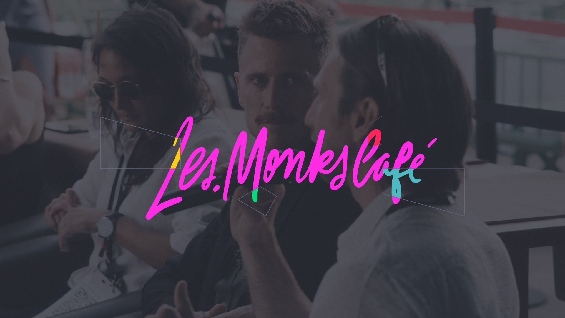 Les.Monks Cafe branding over an image of people speaking