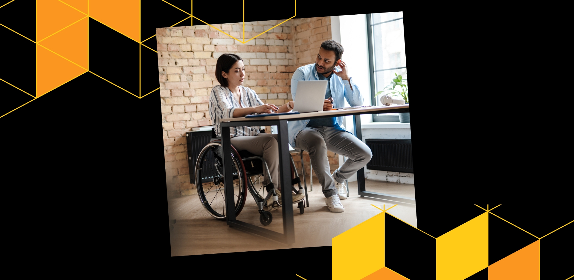 photo of two people at a desk, looking at a laptop, one person in a wheelchair, surrounded by yellow geometric design