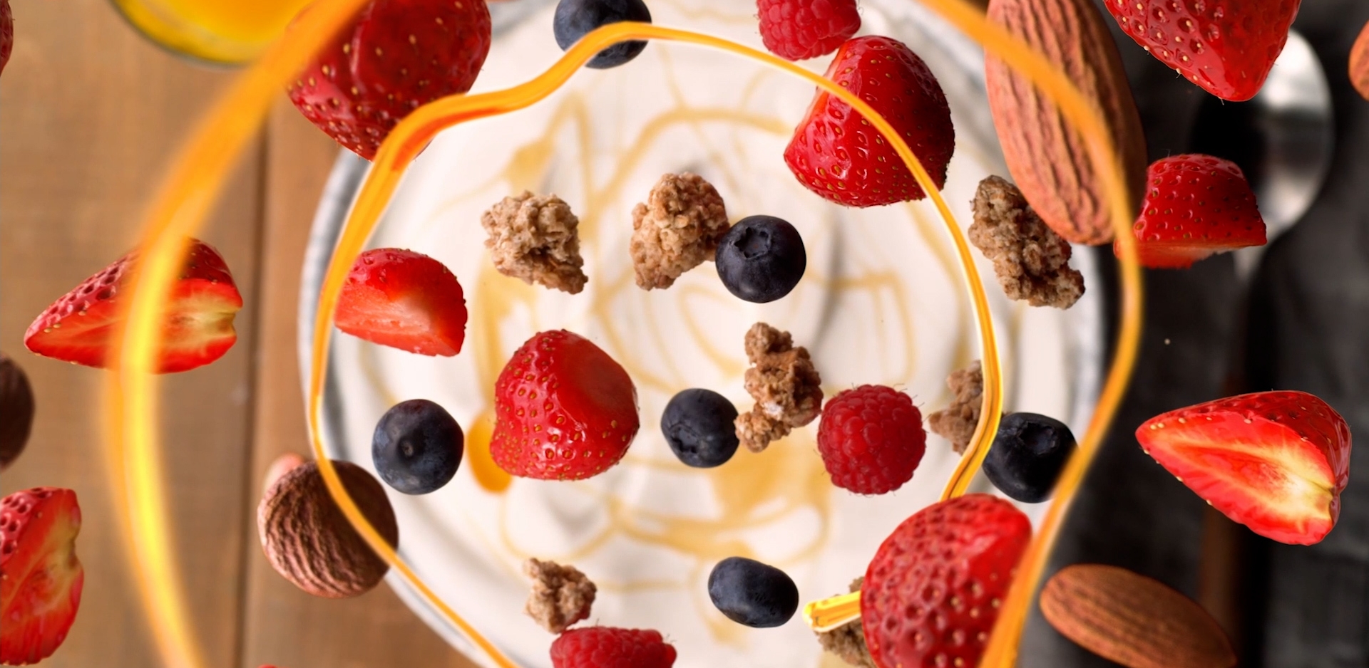 Fruit falling into a bowl of yogurt