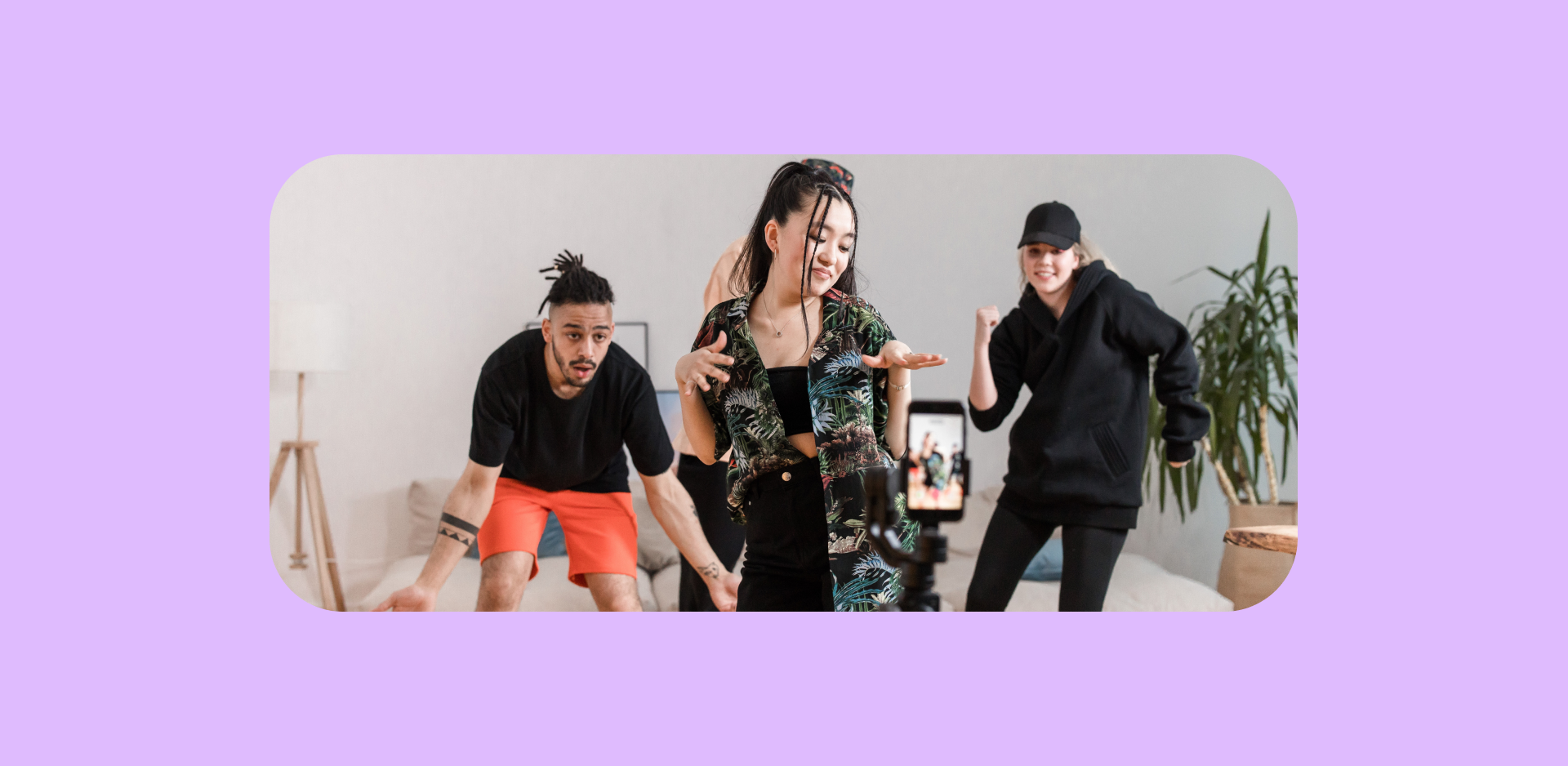 Young students dance in front of a phone