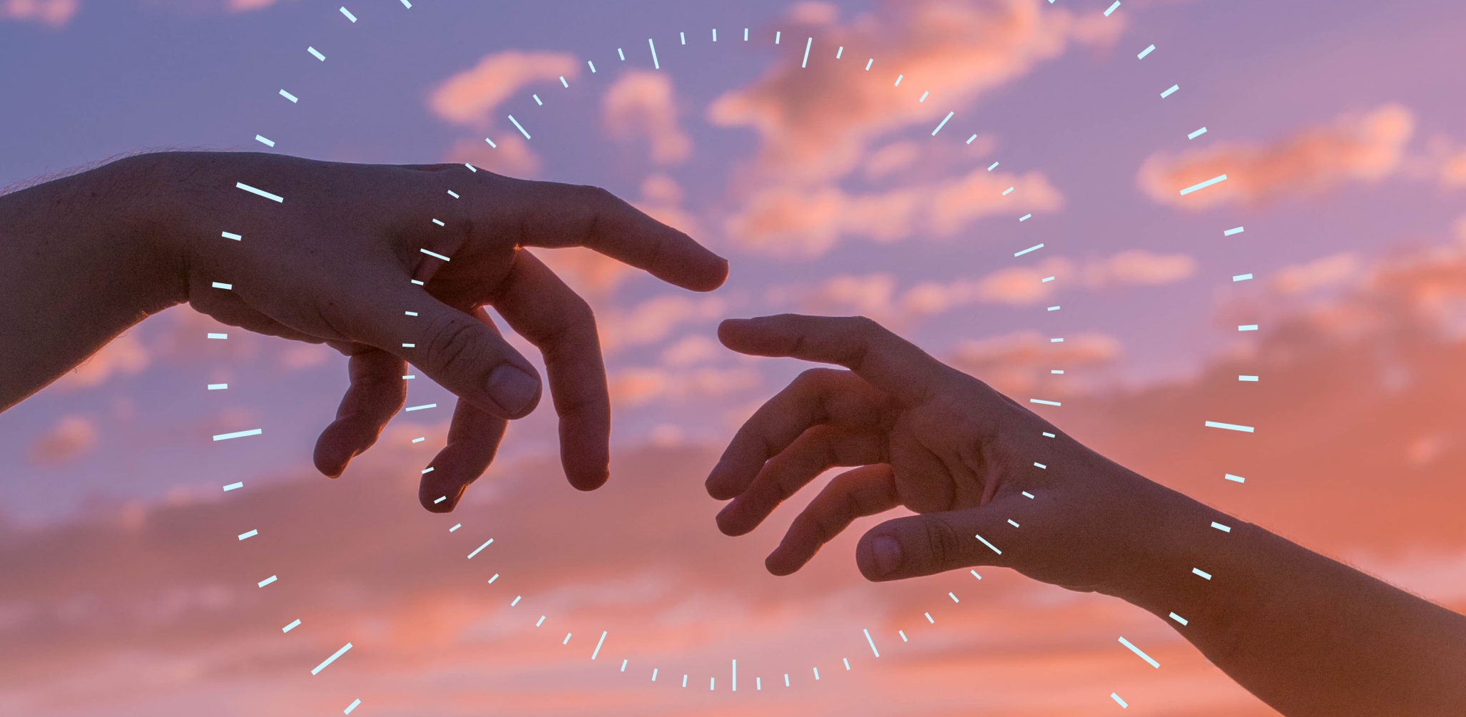 Two hands touching in a sunset