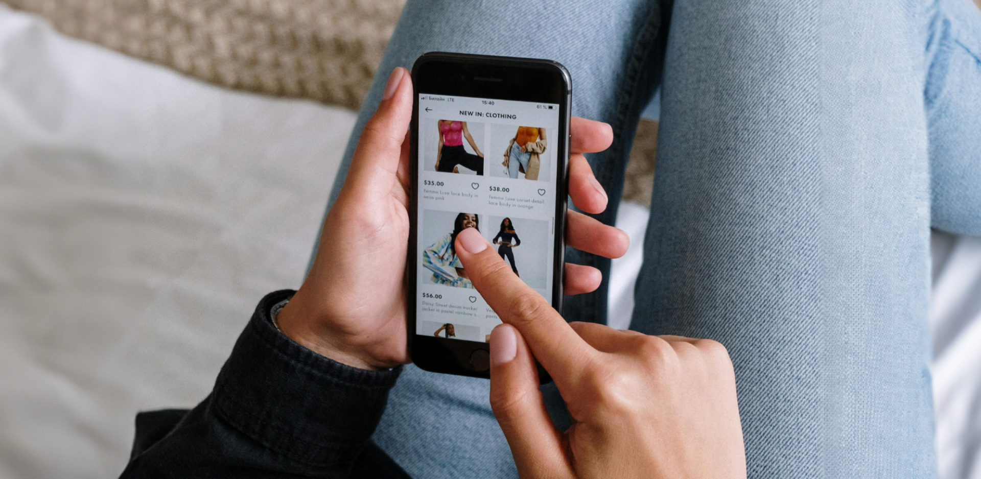 Up-close photo of a smartphone held by someone's hands, who is shopping online.