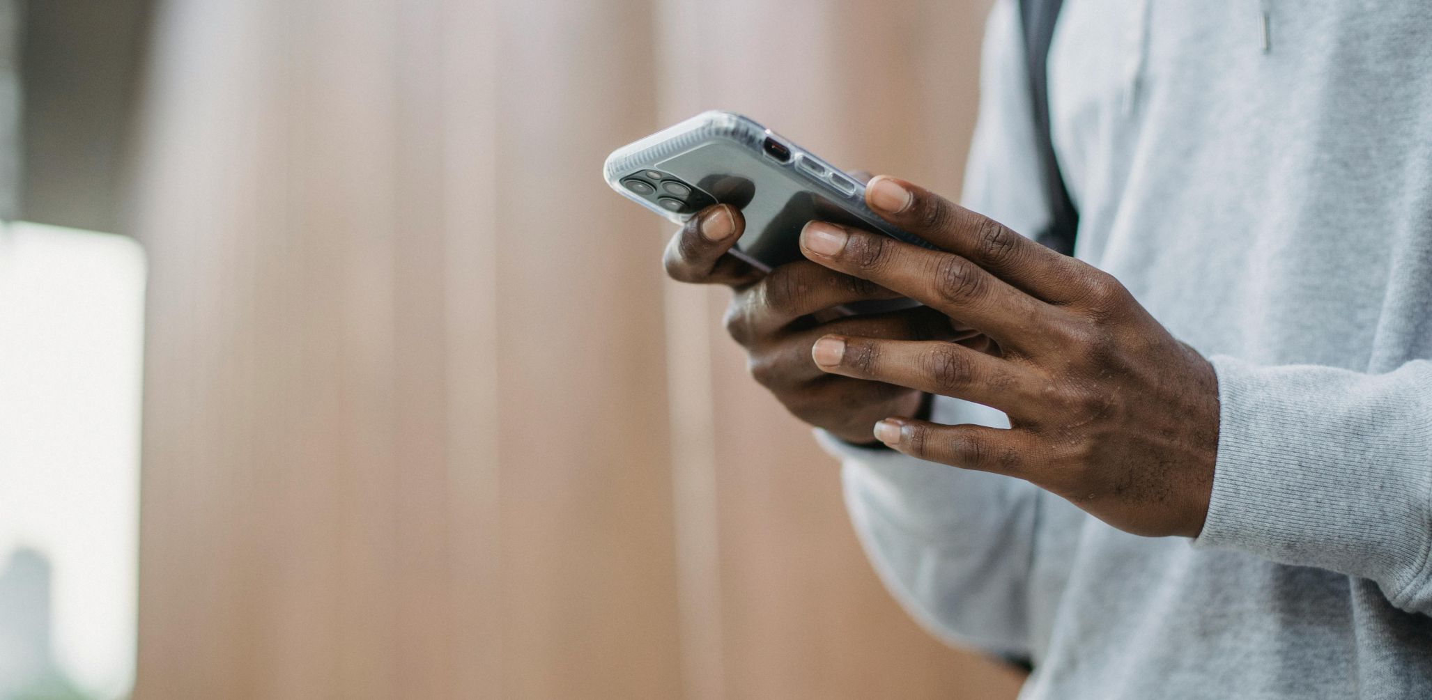 Person holding a cell phone in an office environment