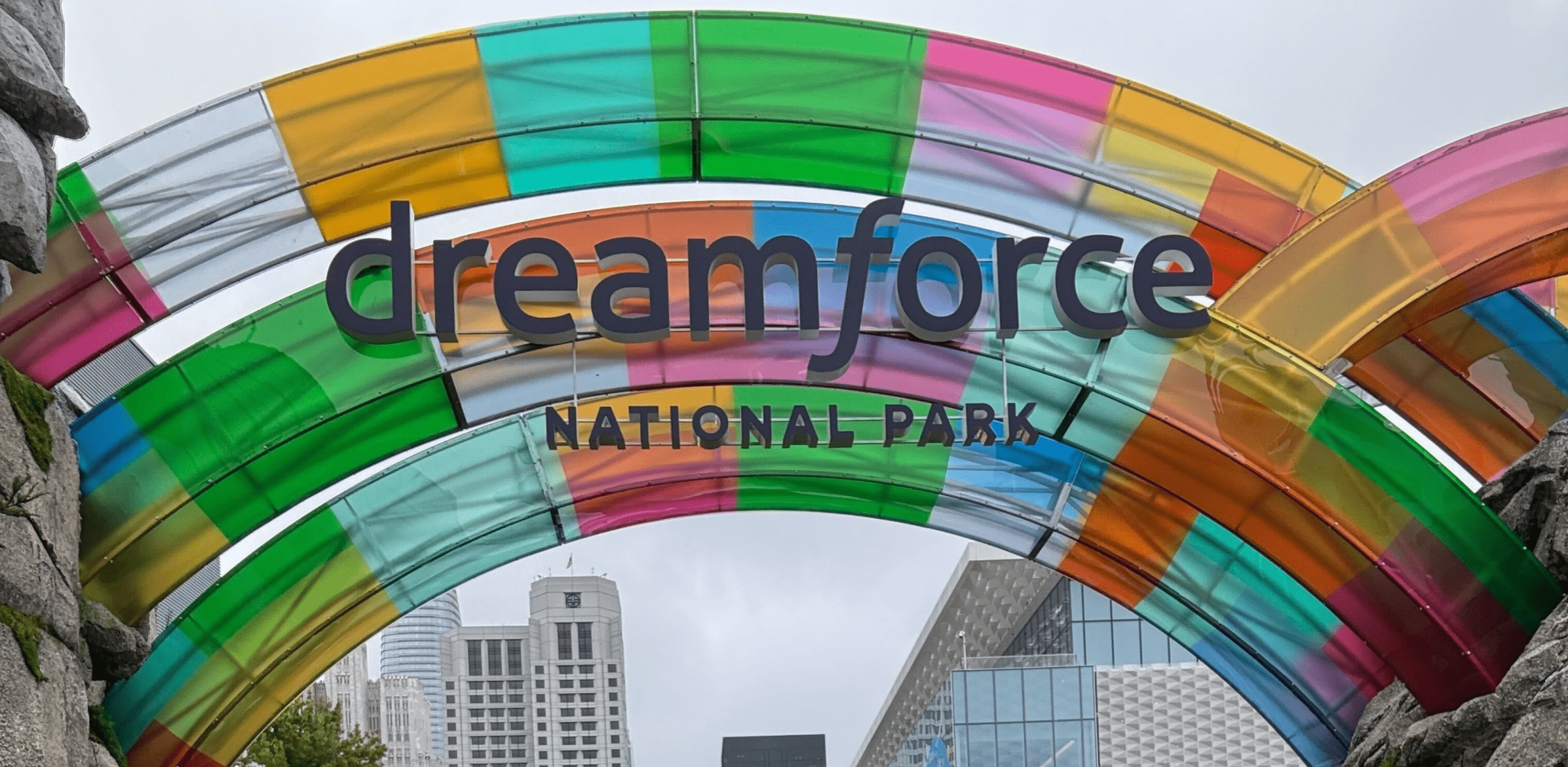 Colorful arch with the words "Dreamforce National Park" in an urban setting.