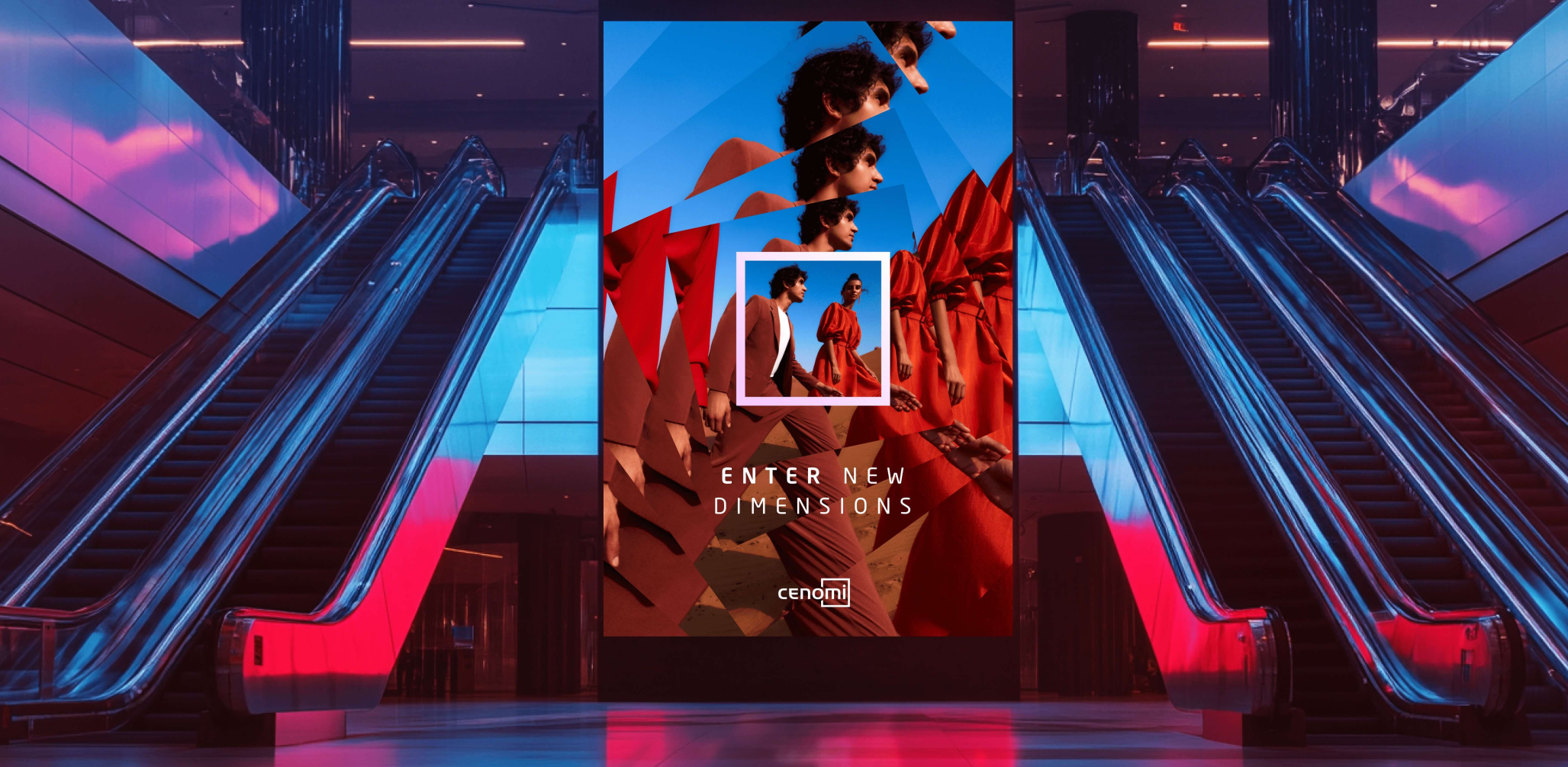 An advertising screen in a transit hub or mall; it is flanked by escalators on each side. The screen reads "Enter new dimensions - Cenomi" and depicts a fashionably dressed man and woman walking in a desert.
