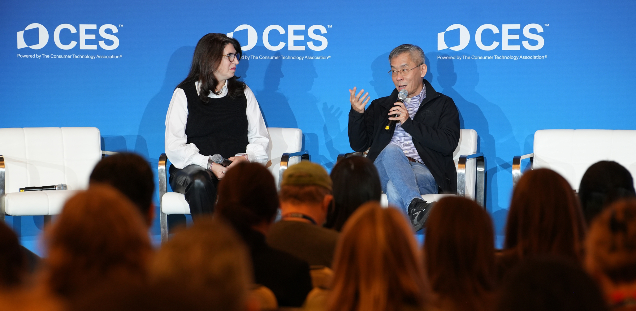 two people sitting on a stage at CES 2025