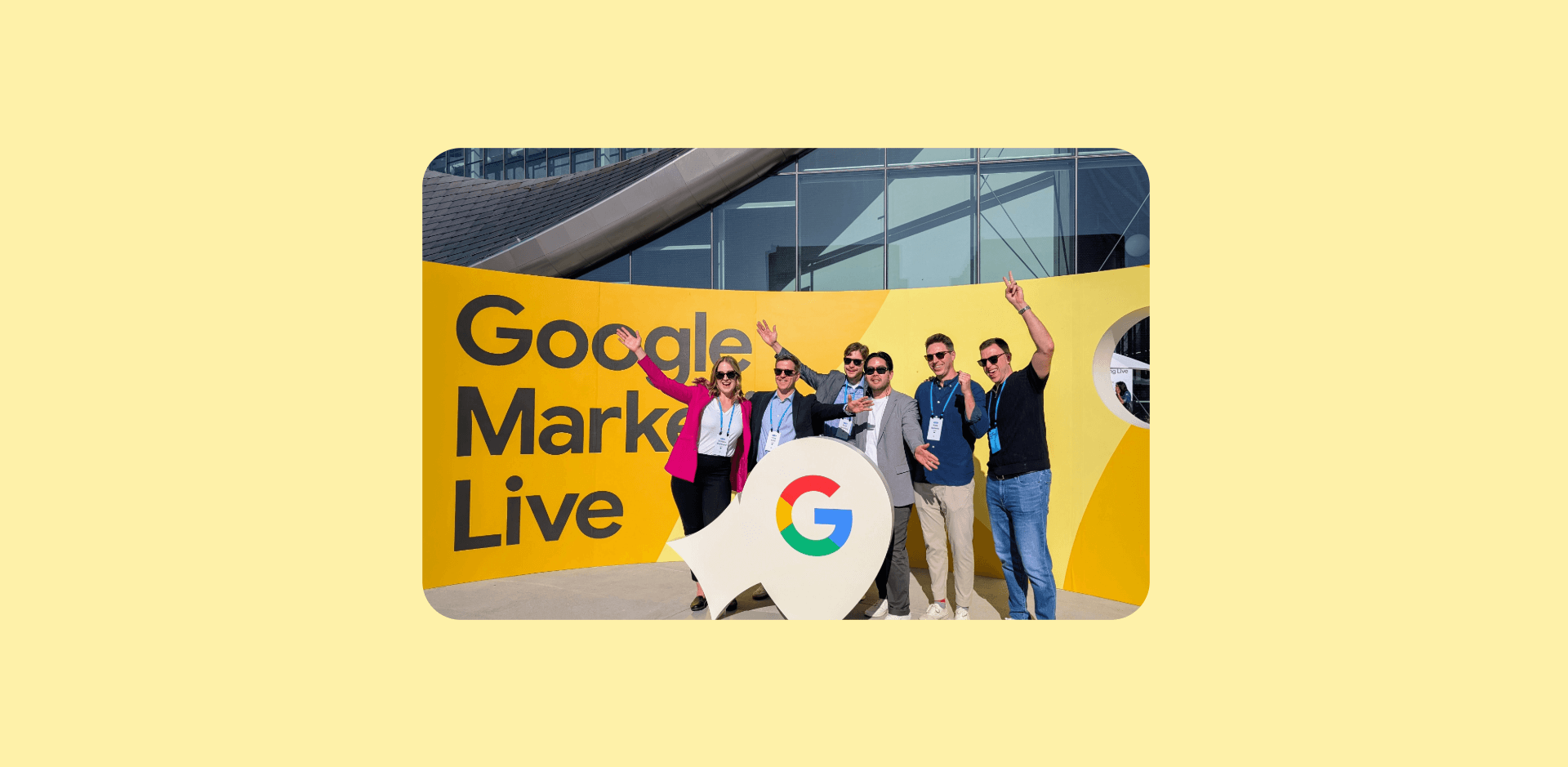 A group photo of Monks standing in front of a banner that reads "Google Marketing Live."