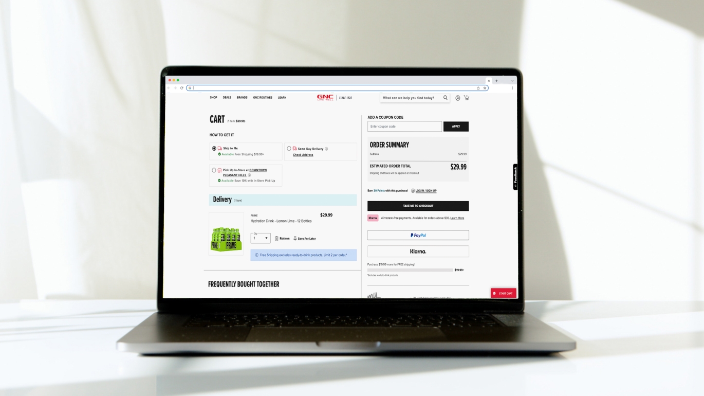 Mockup of a laptop with the GNC website checkout screen visible