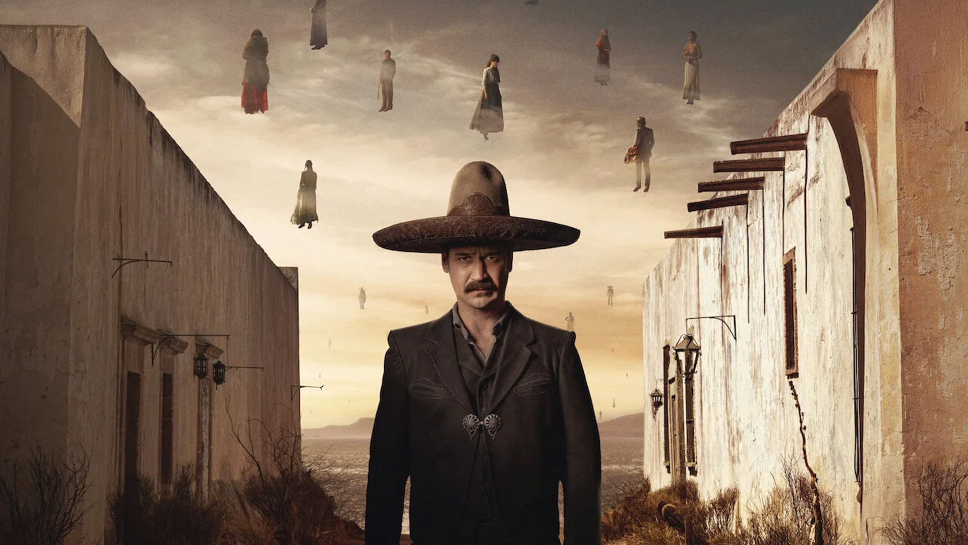 The image depicts a man in traditional Mexican attire and a large sombrero standing in a surreal landscape, with ghostly figures floating above an arid setting framed by old buildings.