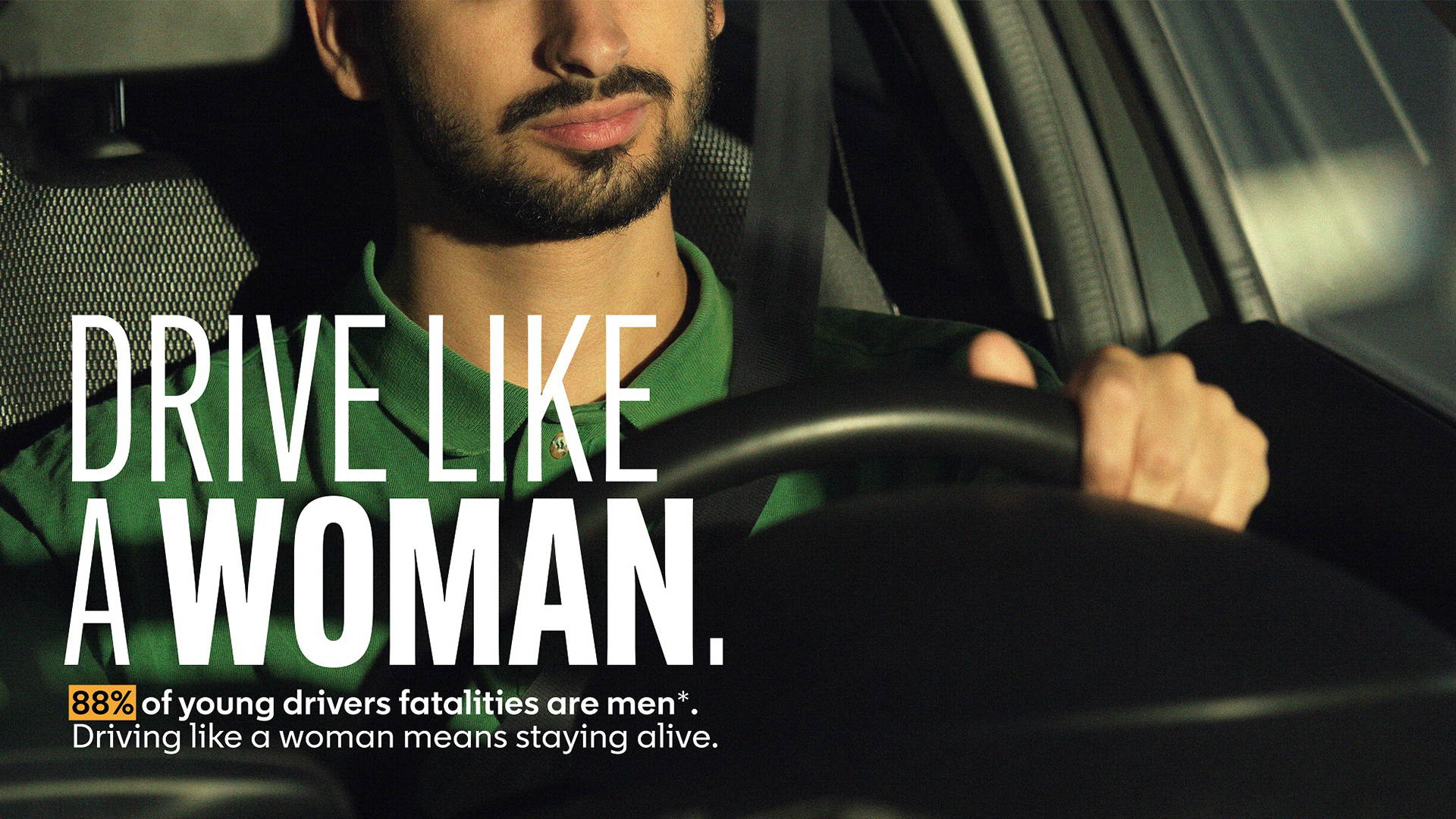 The image shows a young man driving a car with a focused expression, accompanied by text emphasizing that driving like a woman signifies safer driving, highlighted by statistics on young driver fatalities.