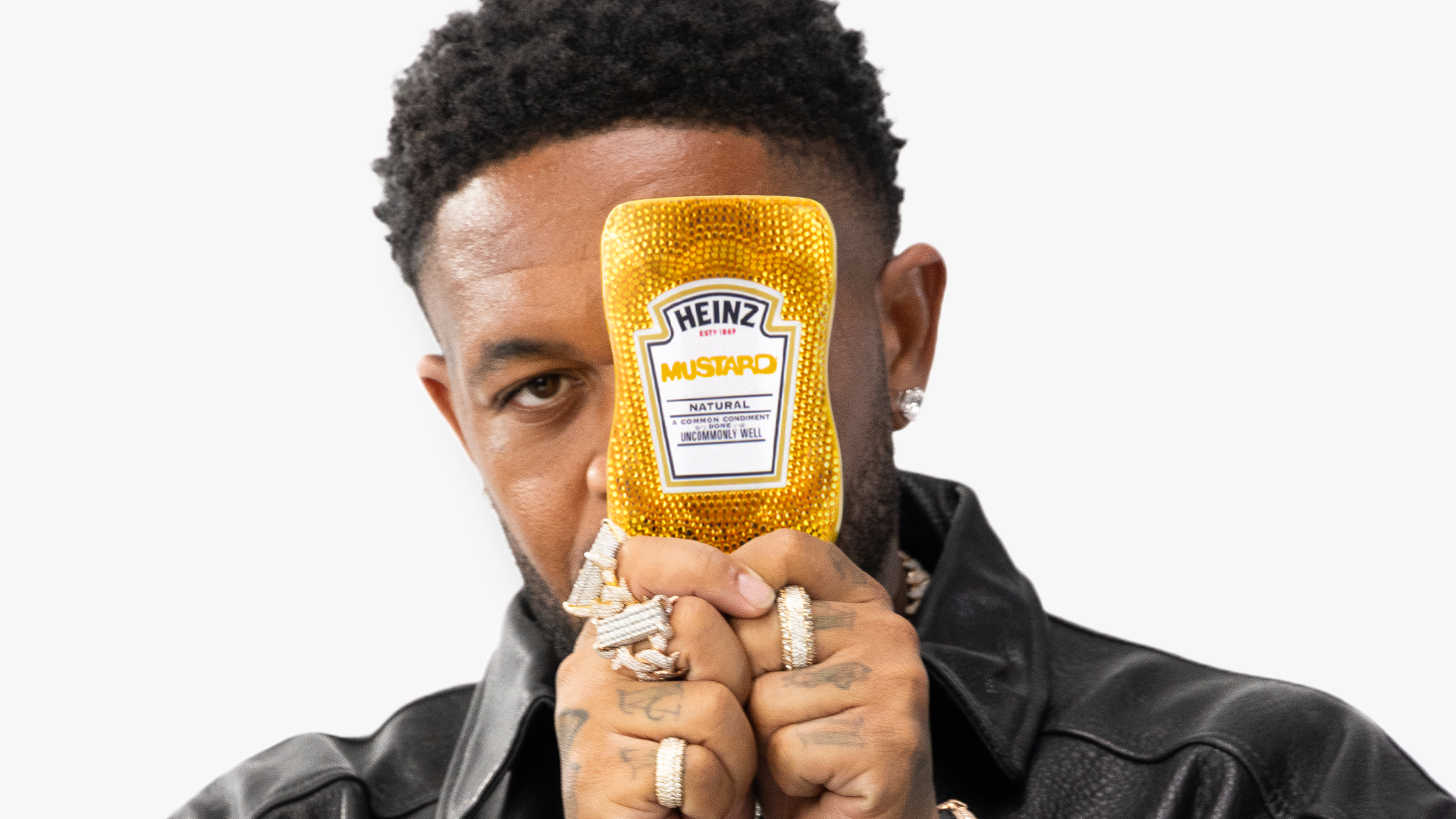 DJ Mustard holds a bedazzled Heinz Mustard bottle