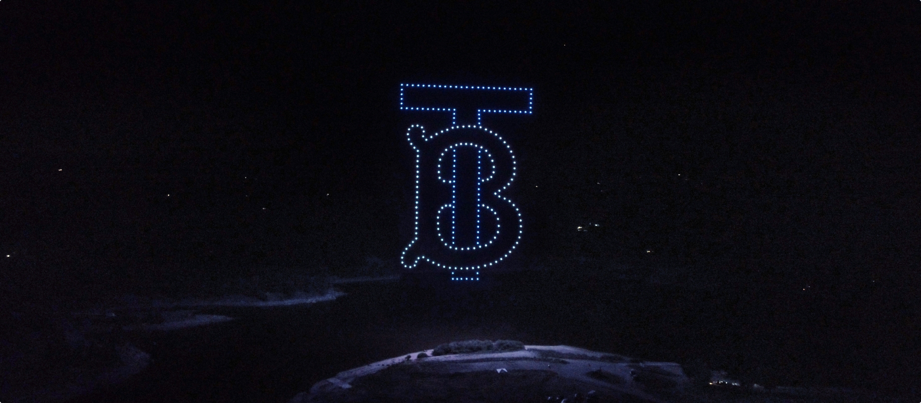 Burberry monogram made up by lights in the sky at night