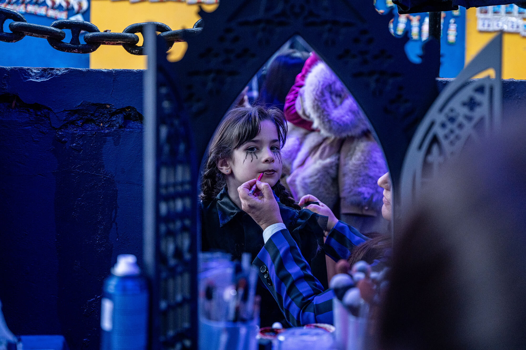 A young girl getting a face painting to look like "Merlina" (Wednesday) Addams during the Darkminito Netflix activation in Caminito, Argentina.