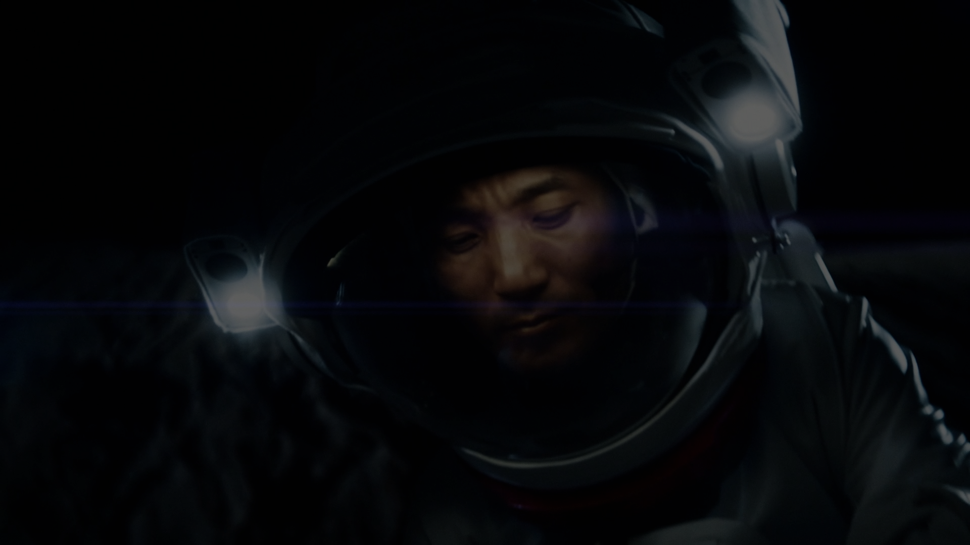 A person in a space suite floating in a dark space