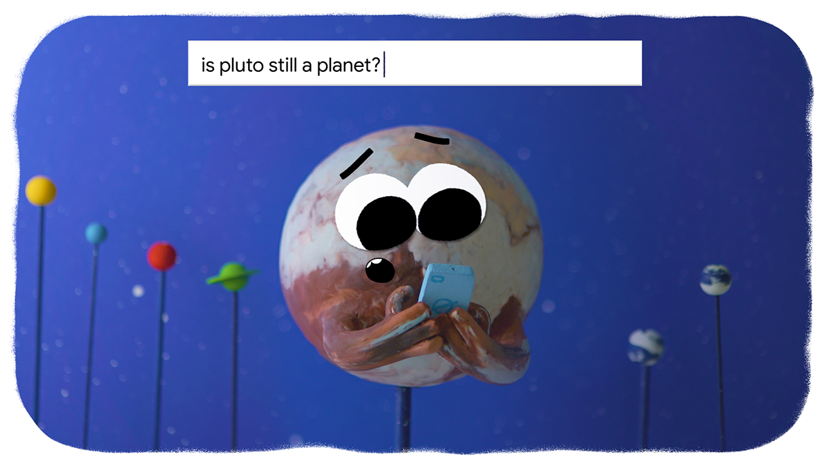 Animation of a planet with a face holding a device in it's arms. In the backgroudn you see different planets in the back on a stick. With at the top the search bar saying: 'is pluto still a planet?'
