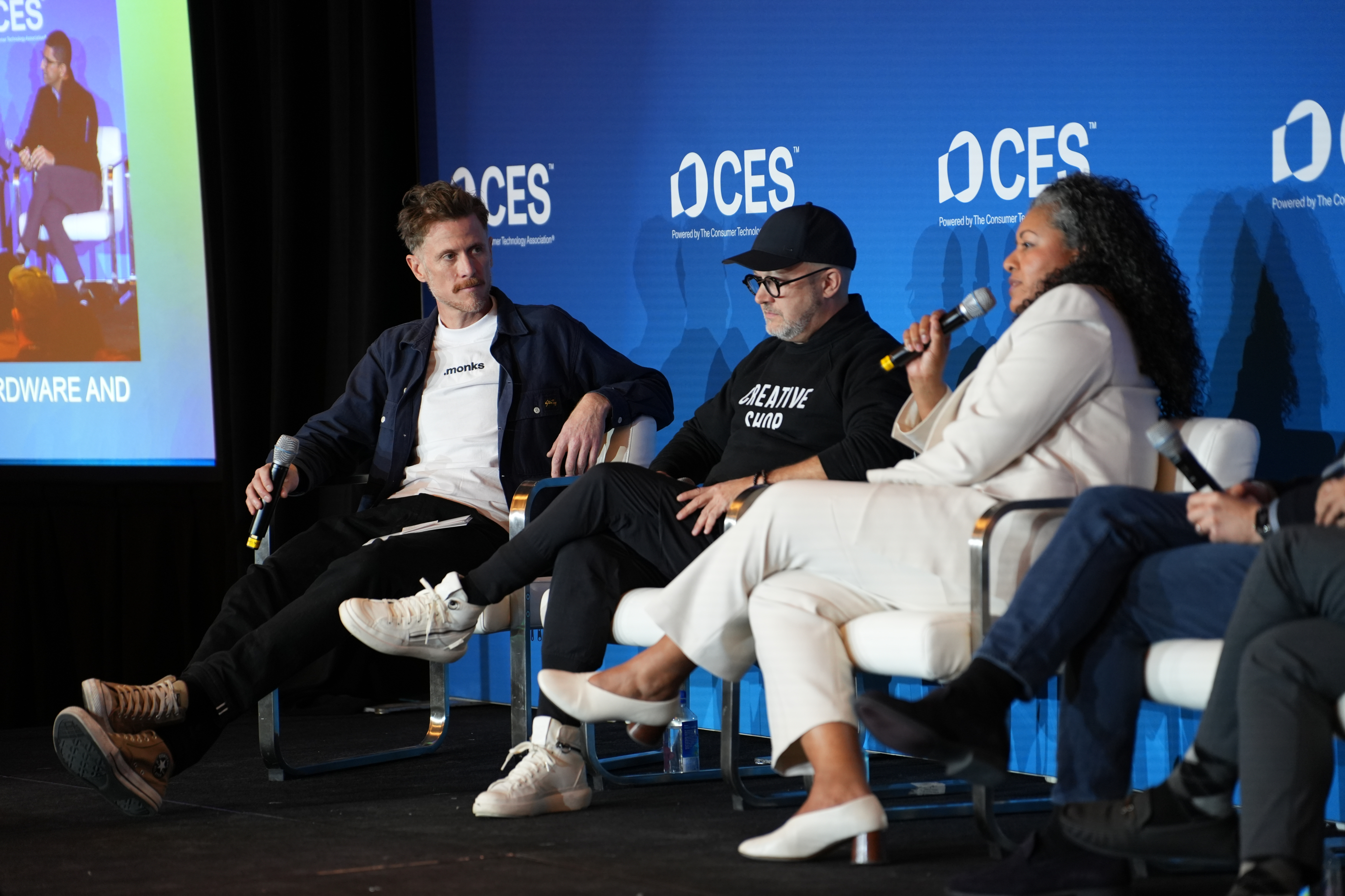 three people sitting on stage at CES