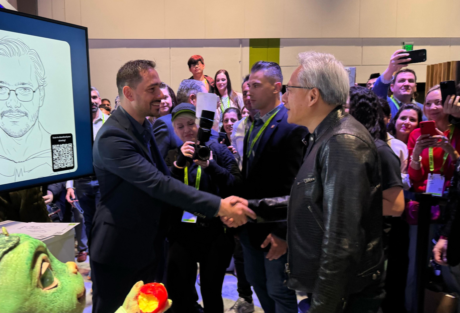NVIDIA CEO Jensen Huang shaking hands with a presenter at GTC 2025