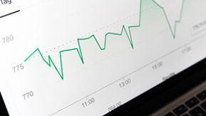A line graph spiking and falling on a laptop