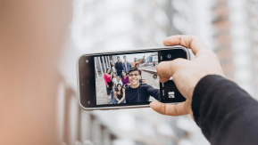 A phone showing someone taking a selfie