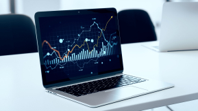 A laptop screen displaying a complex data dashboard with upward-trending charts, representing the measurement of SEO return on investment (ROI) and performance analytics.