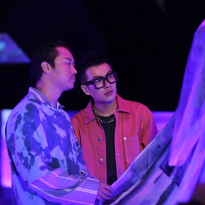 Two people looking at a shirt