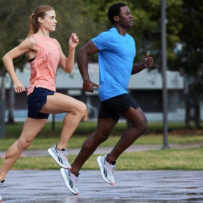 two people running in a park