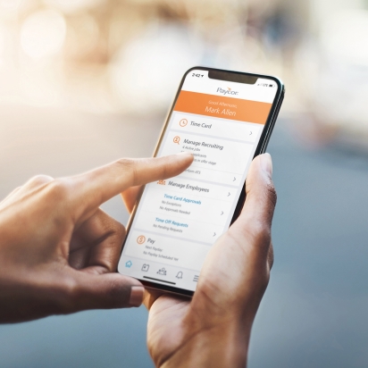 A phone showing Paycor's application interface