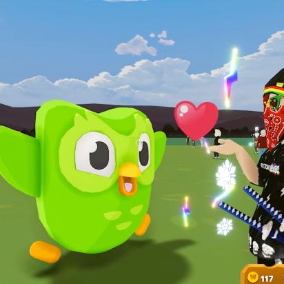 Duo stands in front of an avatar handing it a heart