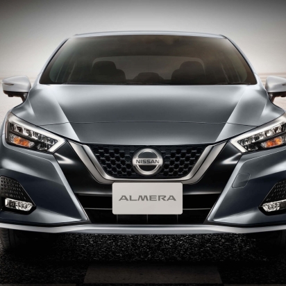 A grey nissan car on the road