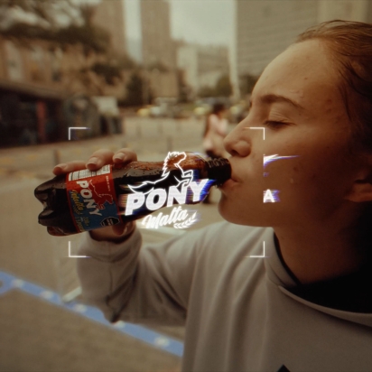 A girl drinking a Pony Malta beverage