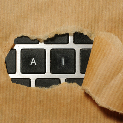 A keyboard being showing behind ripped paper