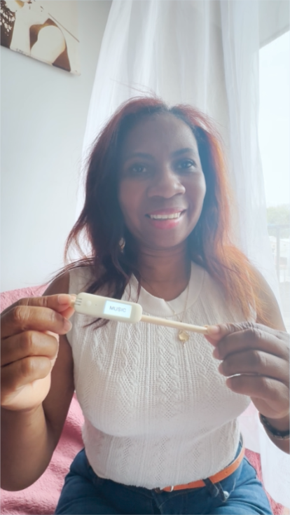 A woman holding the Literacy Pen smiling