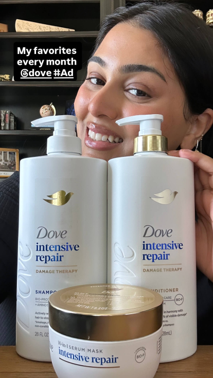An influencer with the Dove hair products on display for her followers