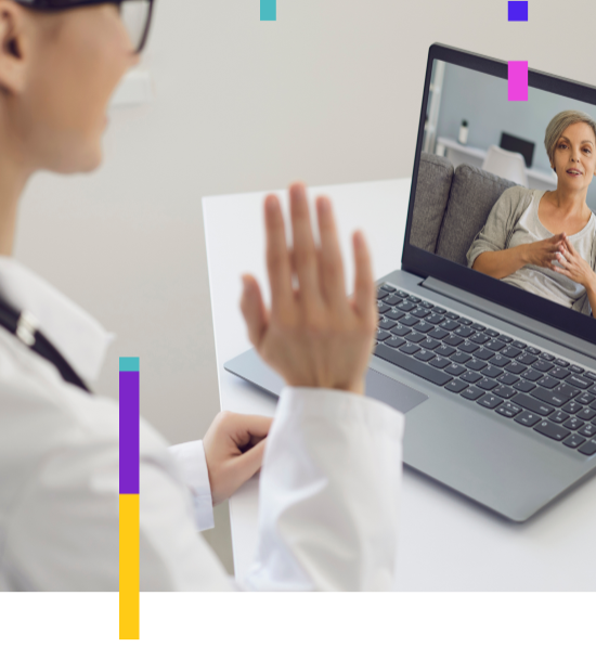 A doctor waiving to a patient via a laptop telehealth appointment