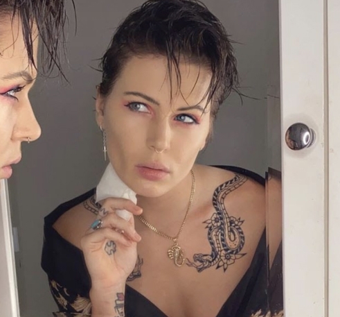 A person applying make up to their face in a mirror