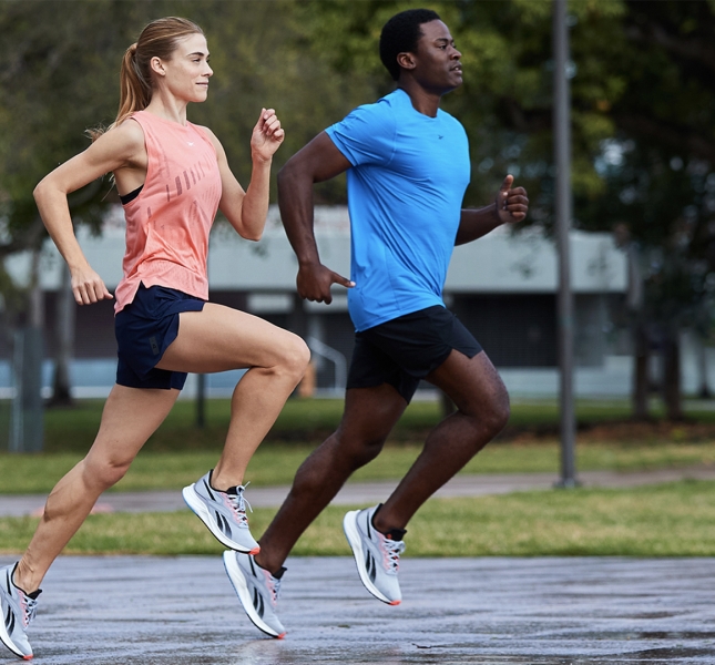 two people running in a park