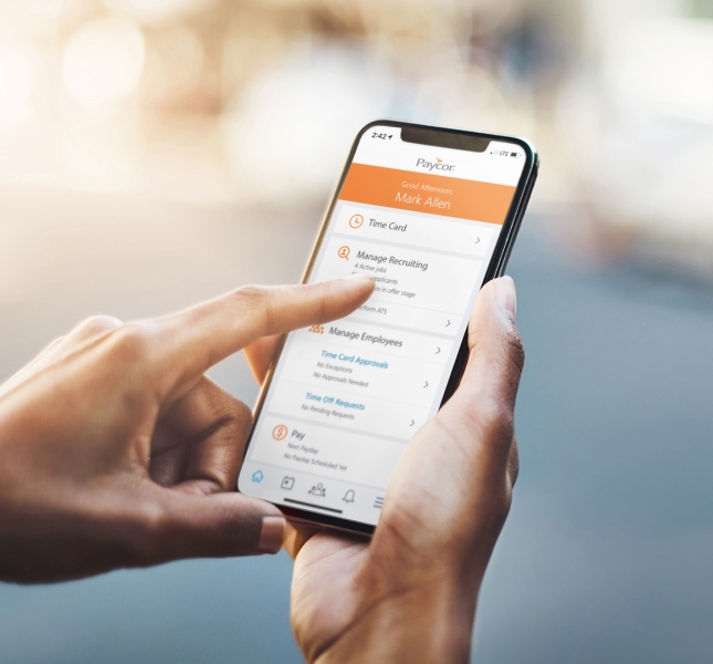A phone showing Paycor's application interface