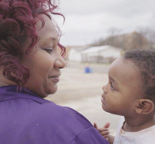 A woman holding a child