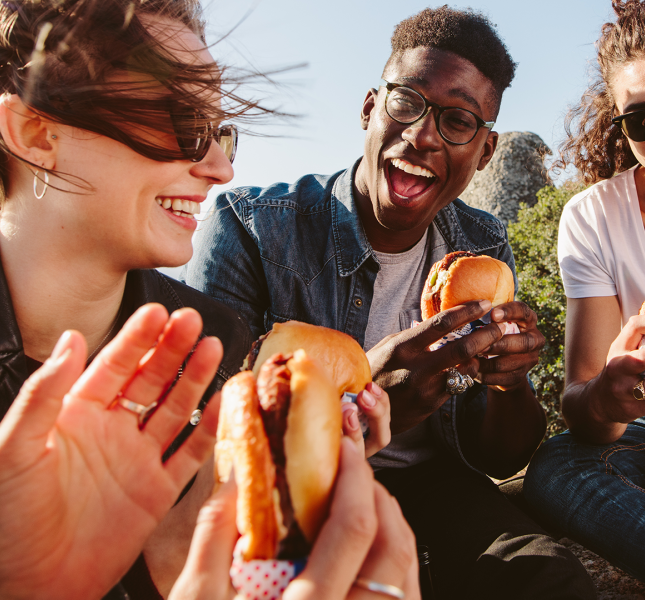 A group of people enjoying hamburgers 