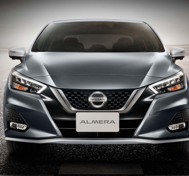A grey nissan car on the road