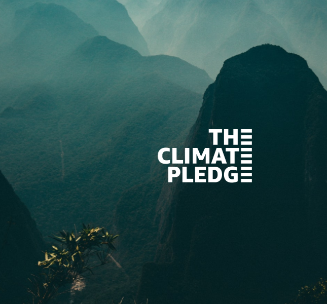 A bunch of green hills with a climate pledge logo centered