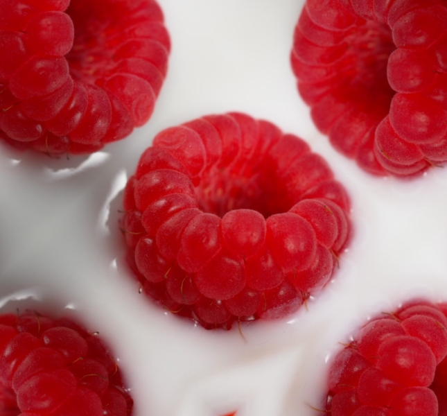 bright red raspberries in yogurt